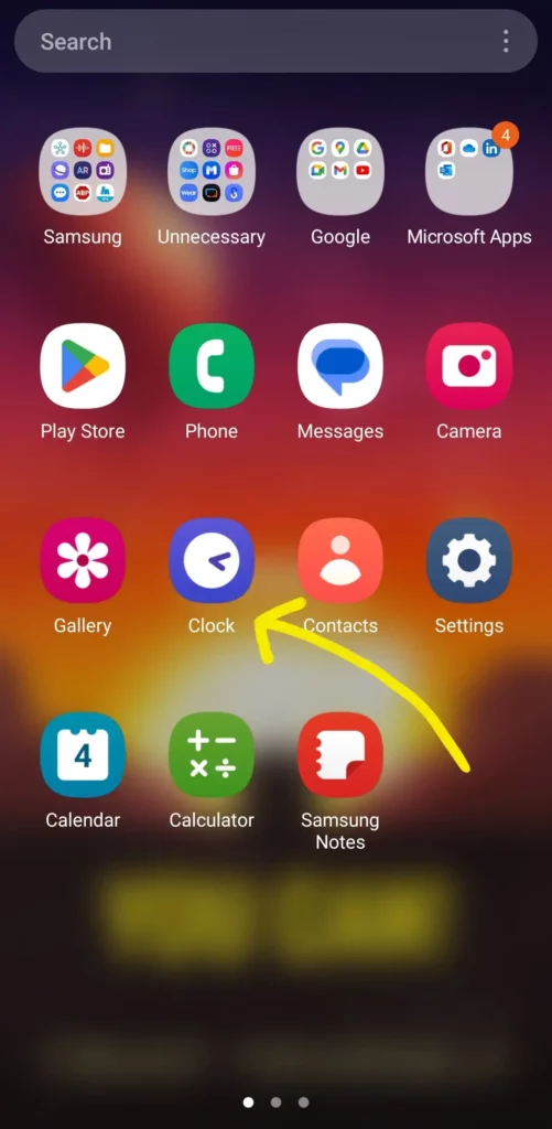 clock app icon highlighted from the app drawer with a yellow arrow